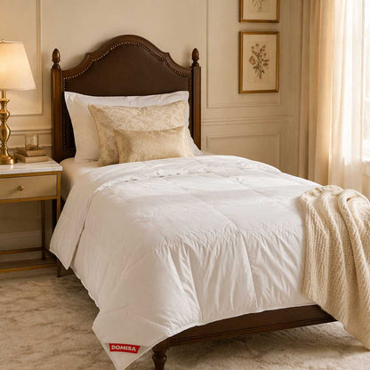 Pilotă albă Domisa Serene 140x200 cm, umplutură 90% puf și 10% pene de gâscă naturală, prezentată pe pat single elegant cu lenjerie crem și decor luxury